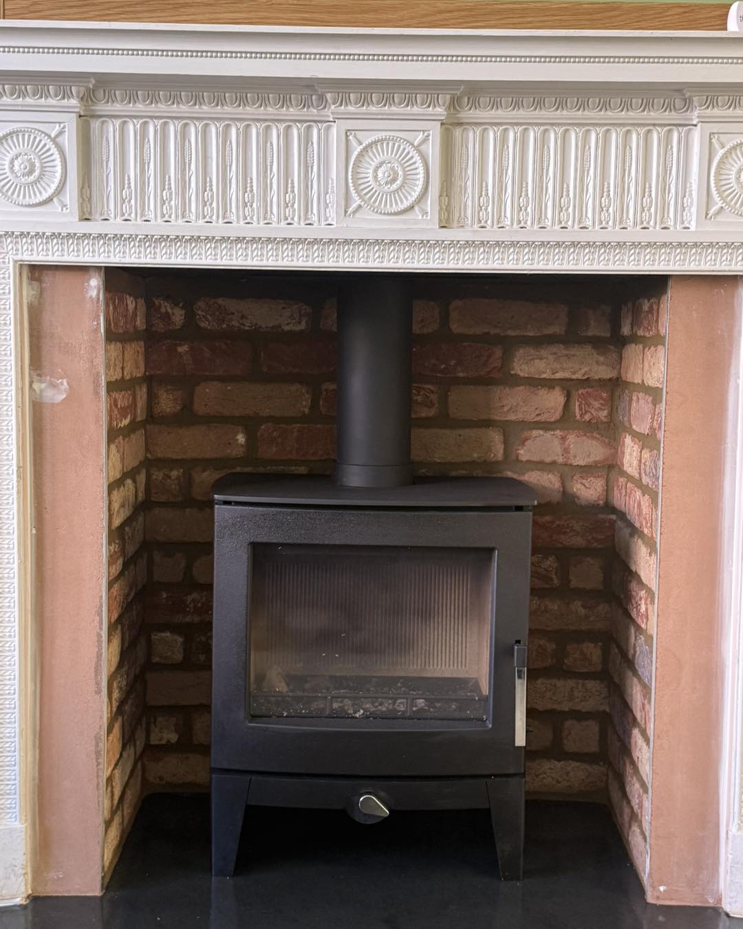 Close-up of decorative cornicing on period fireplace surround